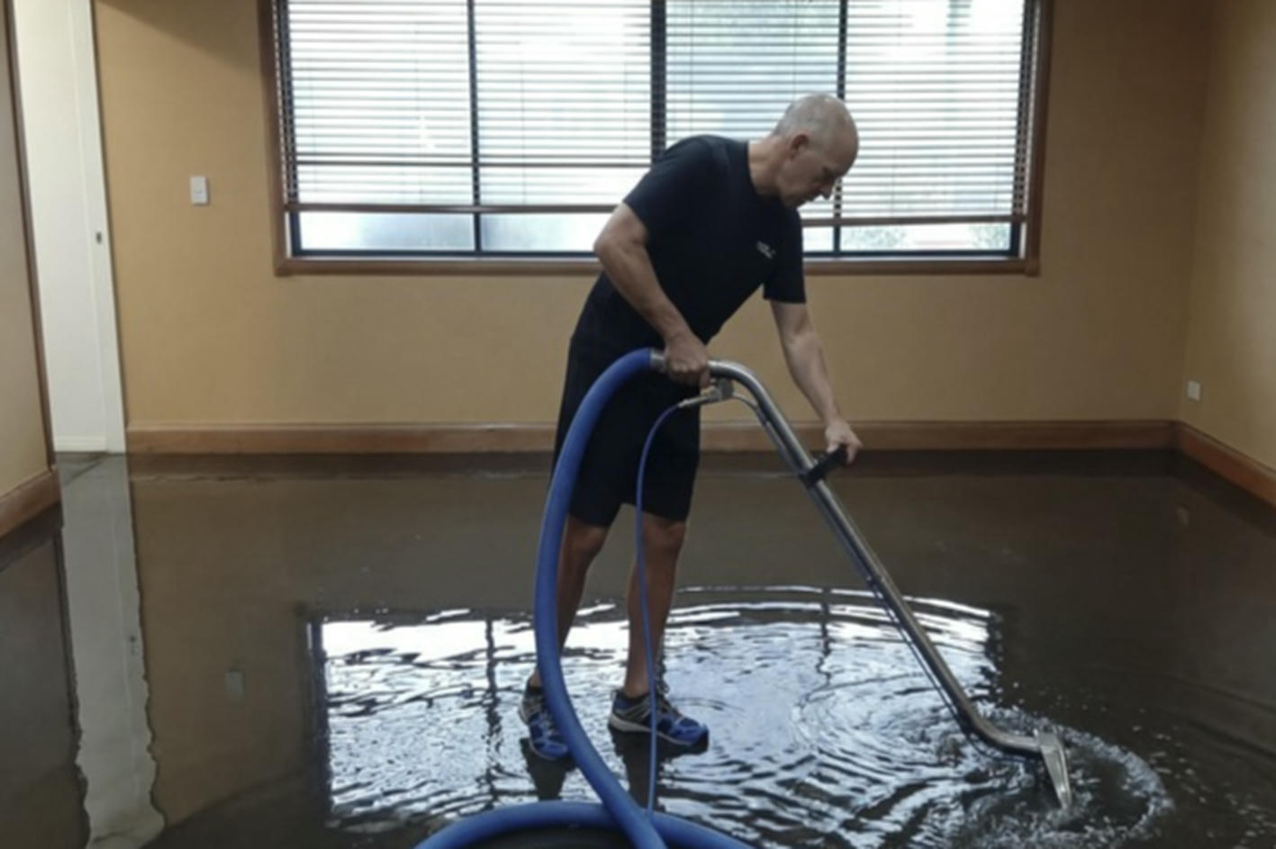 Water removal from a flooded room using extraction equipment in a residential property
