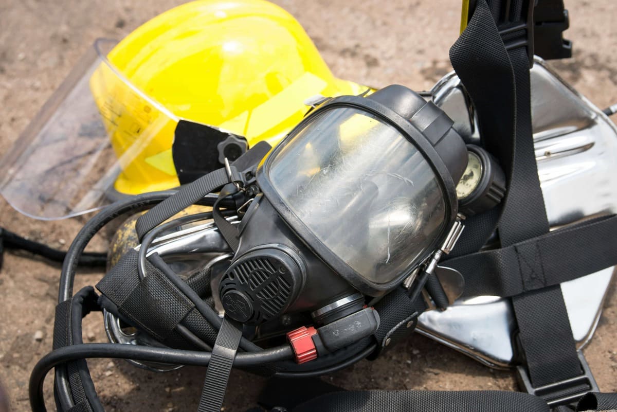 Professional technicians in full PPE gear cleaning up sewage water contamination